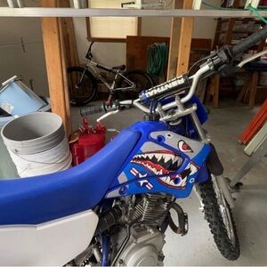 Blue Dirt Bike with Shark Graphics